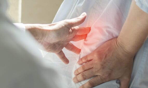 Person suffering from acute lower back pain