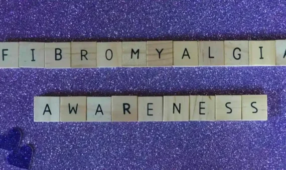 Scrabble tiles spelling out "fibromyalgia awareness"
