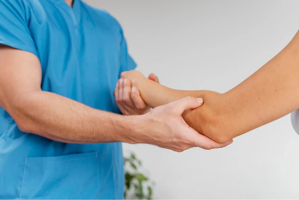 What Is Rheumatology? 6 Healthcare professional examining a patient's arm during a physical assessment.