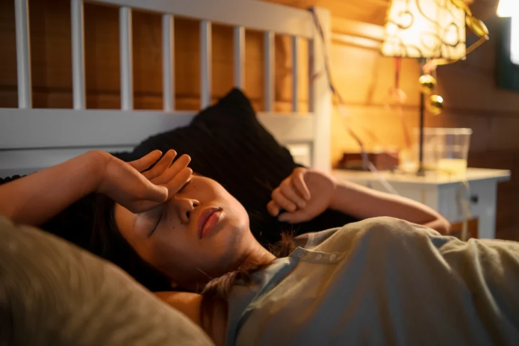Exploring Systemic Autoimmune Diseases 5 Woman lying in bed, appearing fatigued.