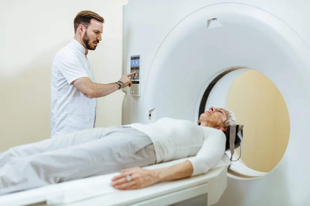 Exploring Systemic Autoimmune Diseases 8 Patient undergoing MRI scan with technician operating the machine.
