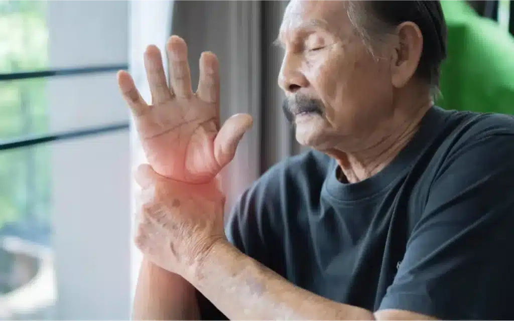 Recognizing the Common Symptoms of Arthritis 5 Elderly man holding his wrist in pain.