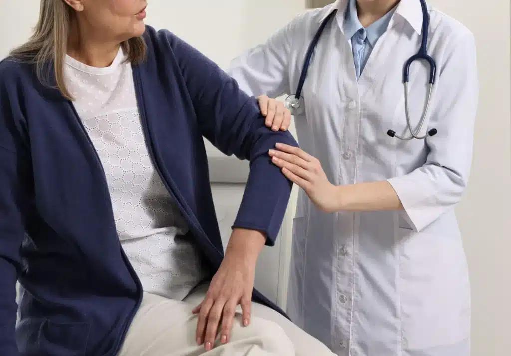 The Role of a Rheumatologist in Your Health 4 A doctor examines a patient's arm during a medical appointment.