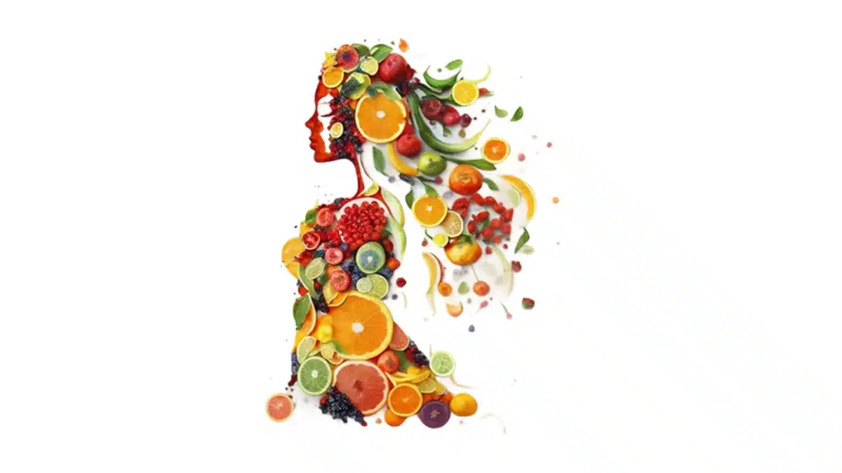 Wellness Services 2 A woman's silhouette made of colorful fruits and slices.