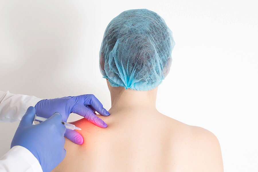 Person getting an injection in their shoulder